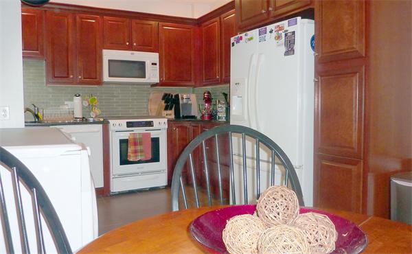 14 Linden Street, Unit 2 Brookline, MA 02445 - Photo 7 of 16 a kitchen with stainless steel appliances granite countertop a refrigerator a stove top oven a sink and dishwasher