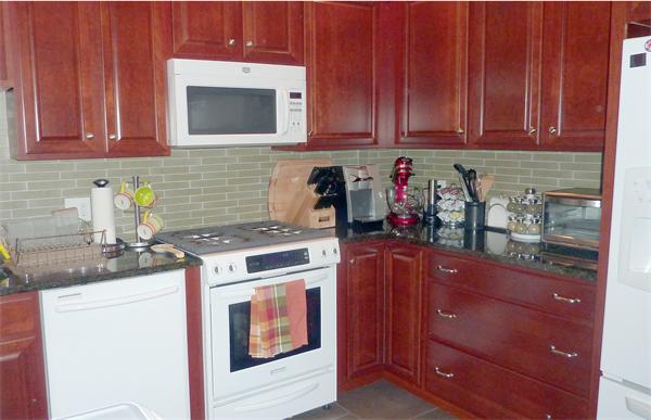 14 Linden Street, Unit 2 Brookline, MA 02445 - Photo 8 of 16 a kitchen with granite countertop wooden cabinets and white appliances