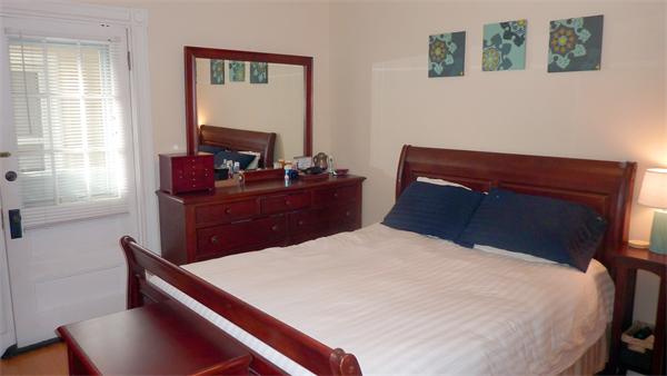 14 Linden Street, Unit 2 Brookline, MA 02445 - Photo 9 of 16 a bed sitting in a bedroom next to a window