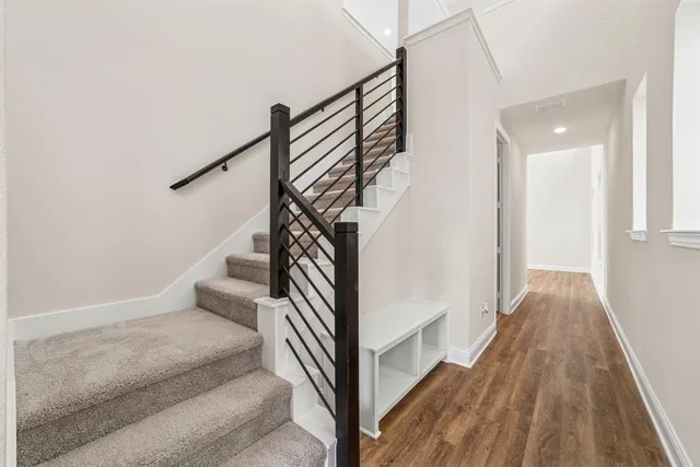 a view of entryway and hall with wooden floor