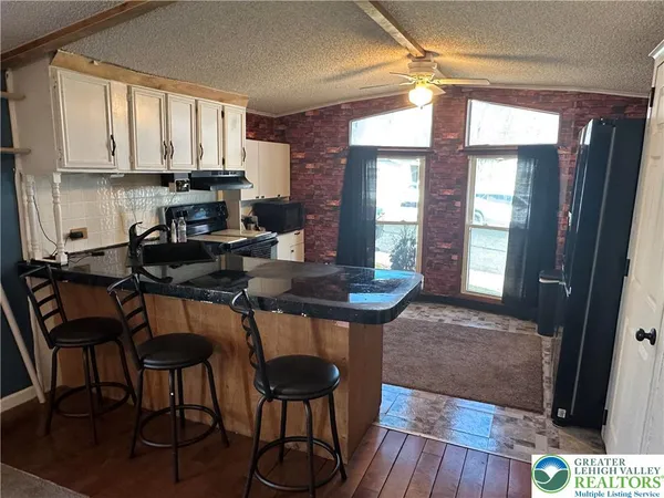 a kitchen with a table chairs and cabinets