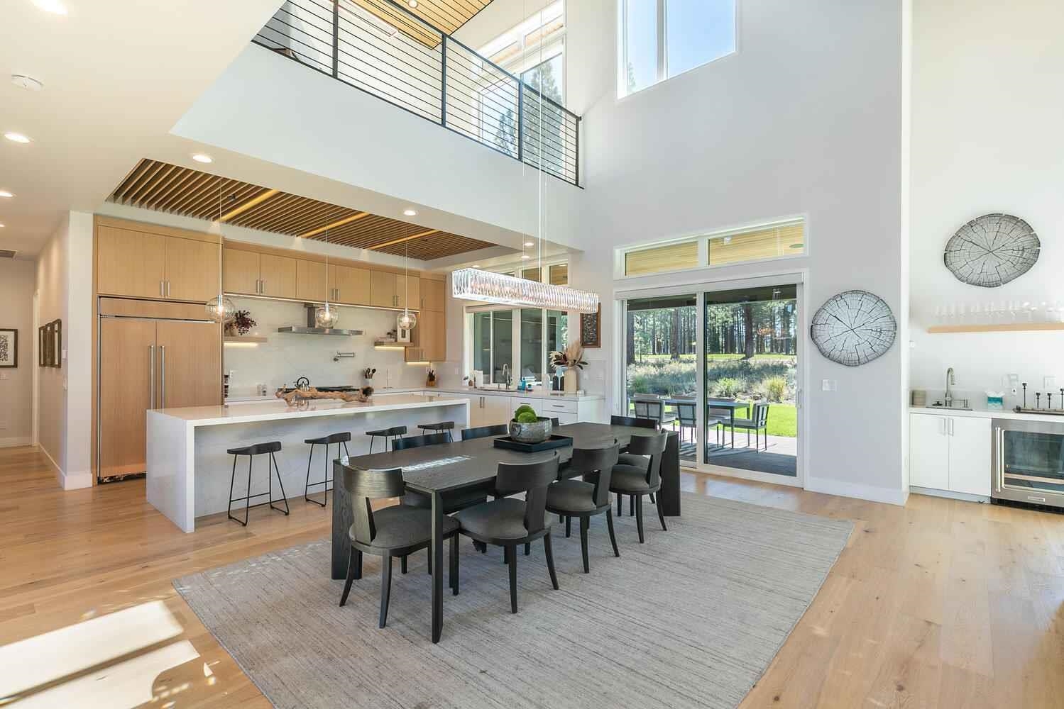 11614 Henness Road Truckee, CA 96161 - Photo 14 of 21 a view of a dining room and livingroom with furniture wooden floor and a rug