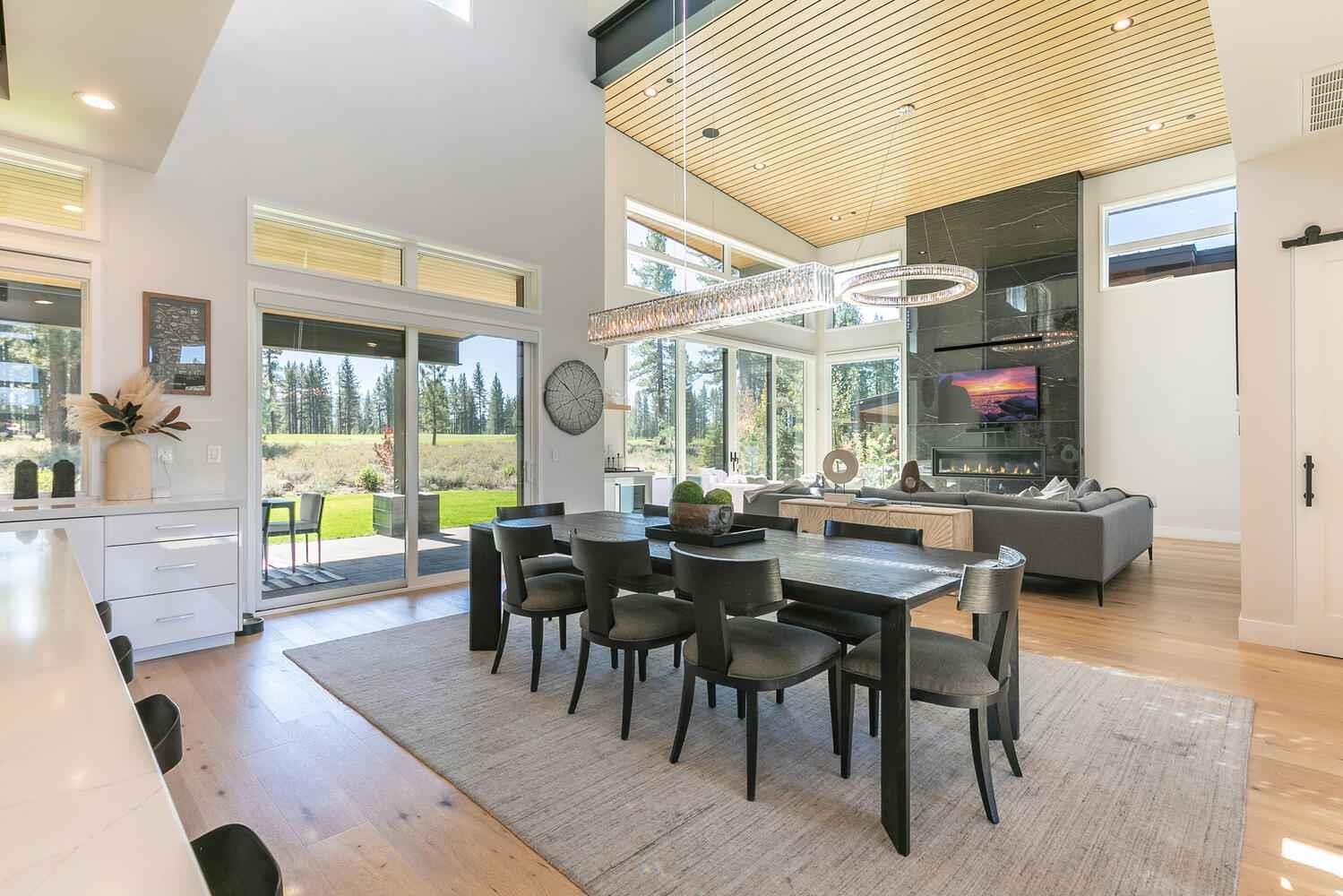 11614 Henness Road Truckee, CA 96161 - Photo 3 of 21 a view of a dining room and livingroom with furniture wooden floor a rug and a chandelier