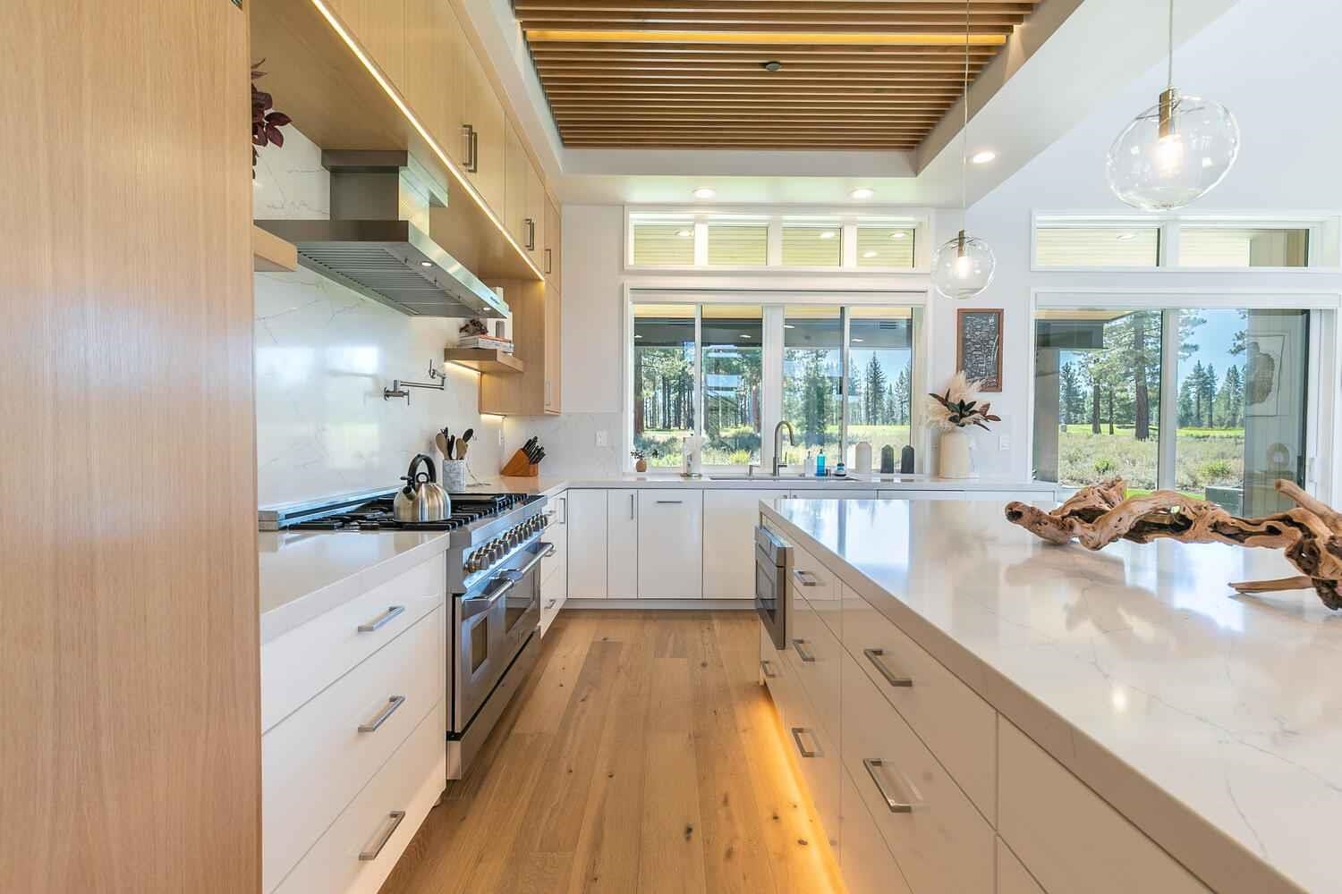 11614 Henness Road Truckee, CA 96161 - Photo 4 of 21 a large kitchen with kitchen island a large window a sink and stainless steel appliances