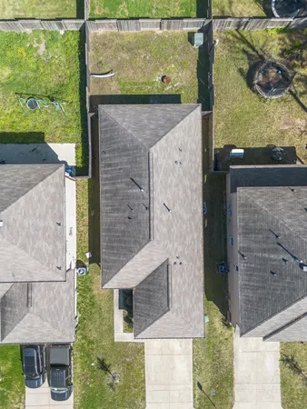 an aerial view of residential houses with outdoor space and street view