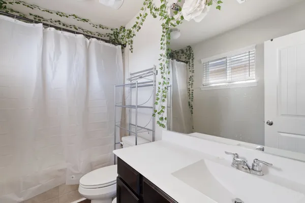 a bedroom with a bed and window