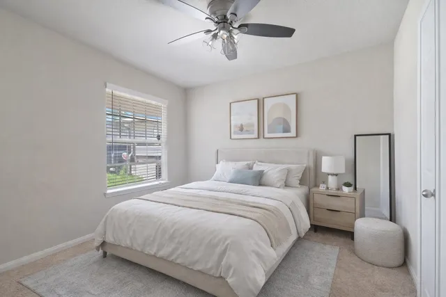 a bedroom with two beds and painting on the wall