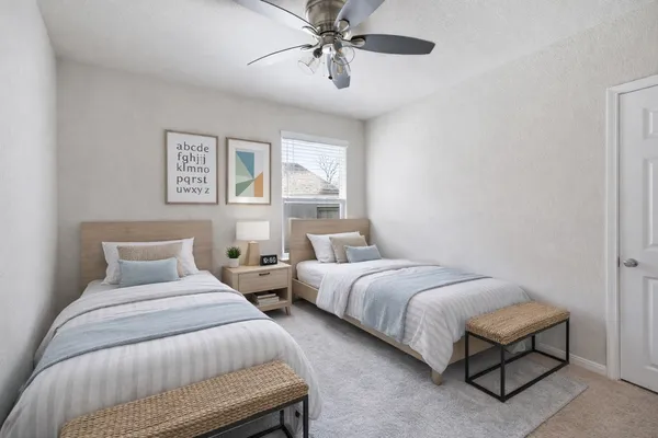 a bedroom with a large bed and a chandelier