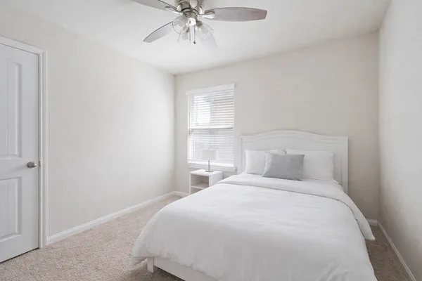 a view of a yard in front of a house with large tree
