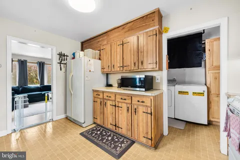 a kitchen with stainless steel appliances a refrigerator and a stove top oven