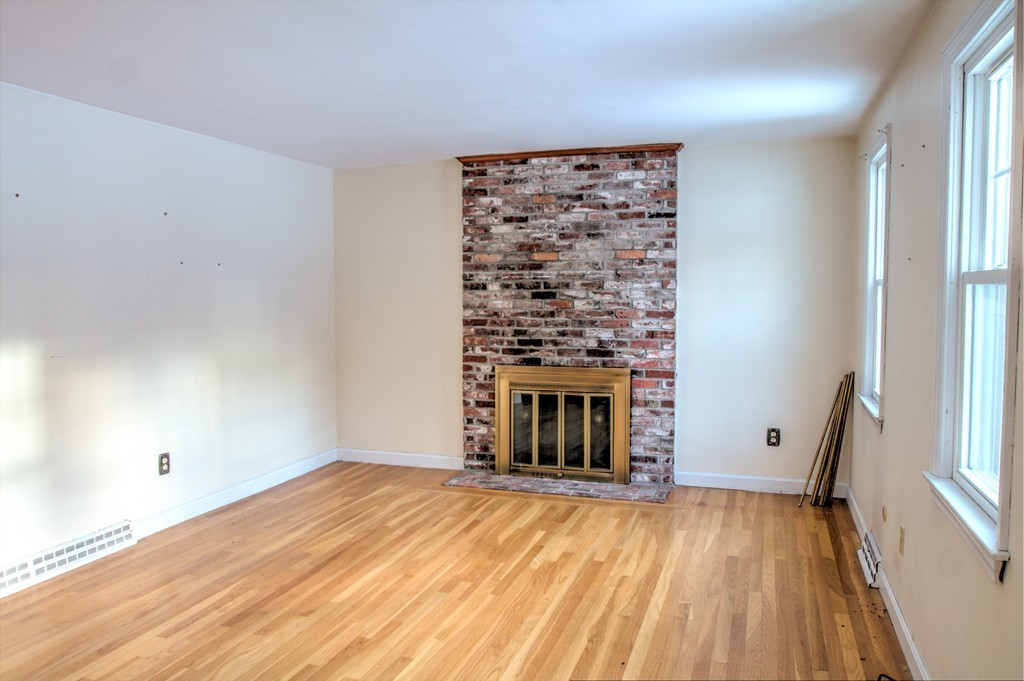 47 Amble Road Chelmsford, MA 01824 - Photo 11 of 30 a view of empty room with fireplace and wooden floor