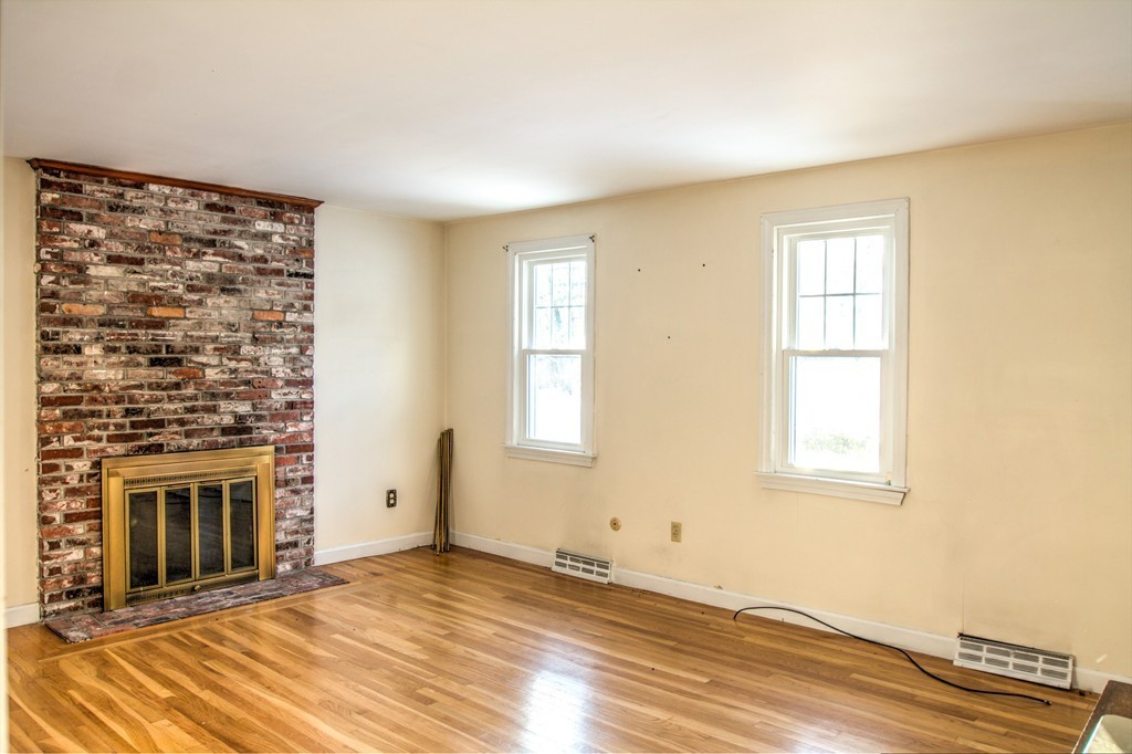 47 Amble Road Chelmsford, MA 01824 - Photo 13 of 30 a view of an empty room with a fireplace and a window