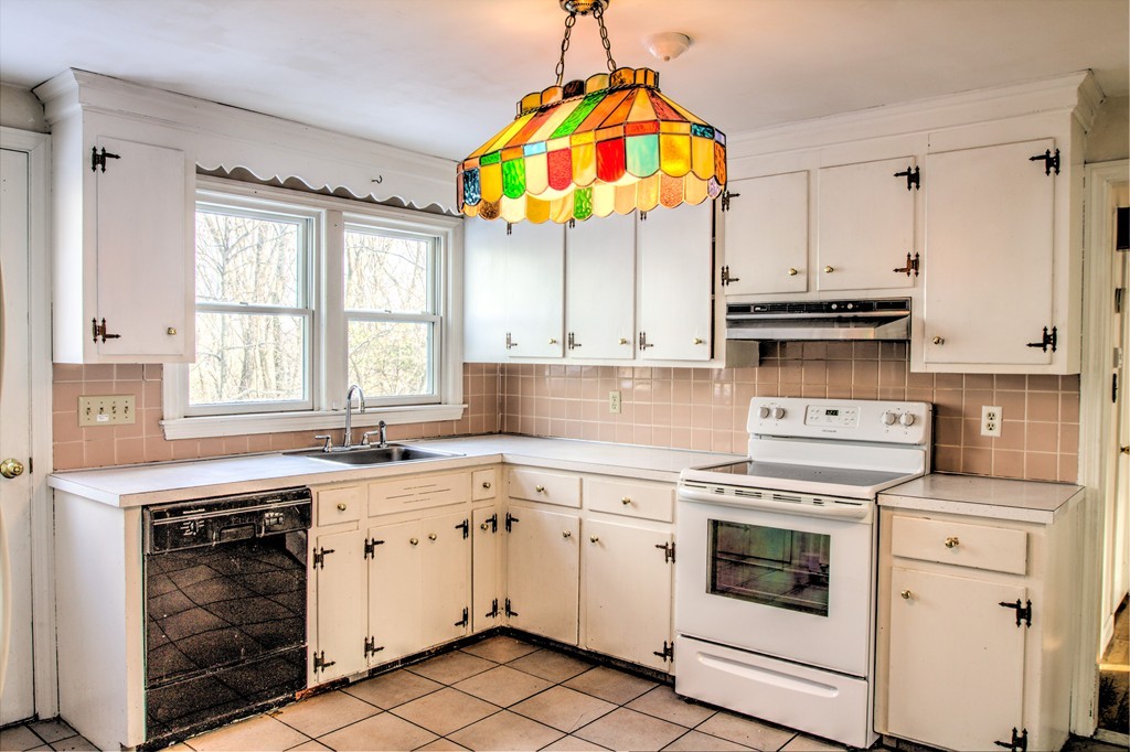 47 Amble Road Chelmsford, MA 01824 - Photo 2 of 30 a kitchen with stainless steel appliances granite countertop a stove a sink and a microwave