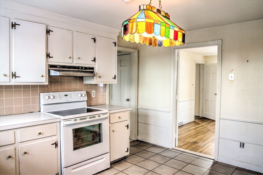 47 Amble Road Chelmsford, MA 01824 - Photo 4 of 30 a kitchen with stainless steel appliances granite countertop a stove a refrigerator and a stove