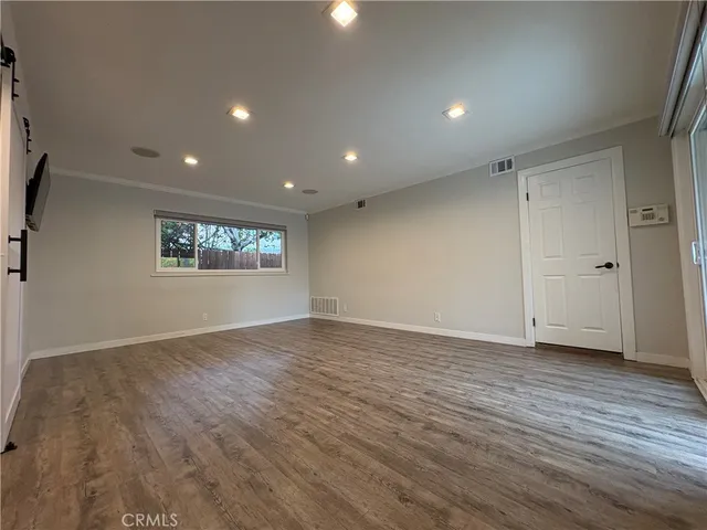 a view of an empty room and a window