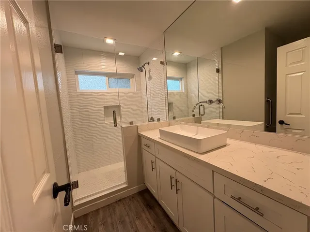 a bathroom with double vanity sink and mirror