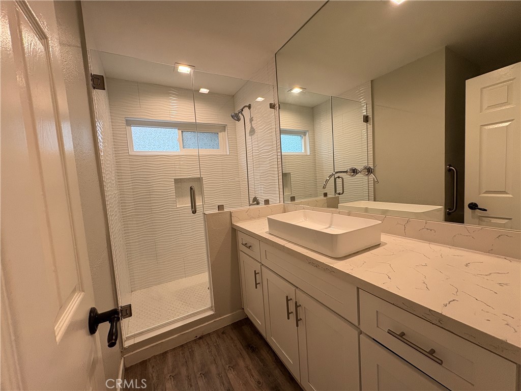 1 Hopkins Street Irvine, CA 92612 - Photo 17 of 37 a bathroom with double vanity sink and mirror