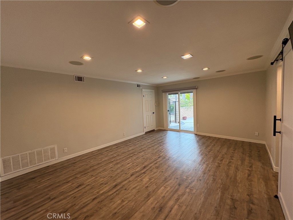 1 Hopkins Street Irvine, CA 92612 - Photo 18 of 37 a view of empty room with wooden floor and fan