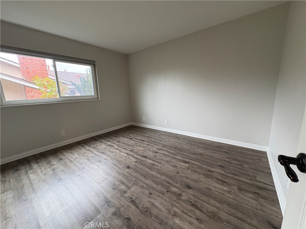 1 Hopkins Street Irvine, CA 92612 - Photo 19 of 37 a view of an empty room with wooden floor and a window