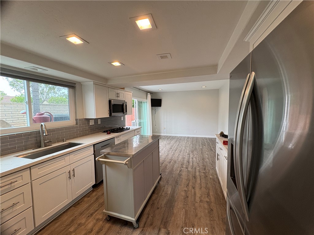 1 Hopkins Street Irvine, CA 92612 - Photo 8 of 37 a kitchen with a sink refrigerator and microwave
