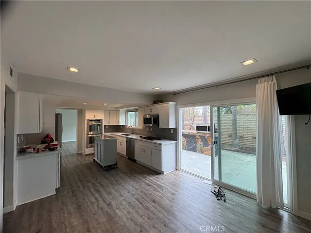a kitchen with a table and chairs in it