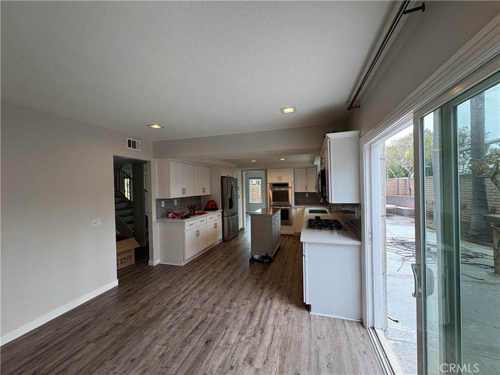 1 Hopkins Street Irvine, CA 92612 - Photo 10 of 37 a kitchen with a refrigerator and wooden floor