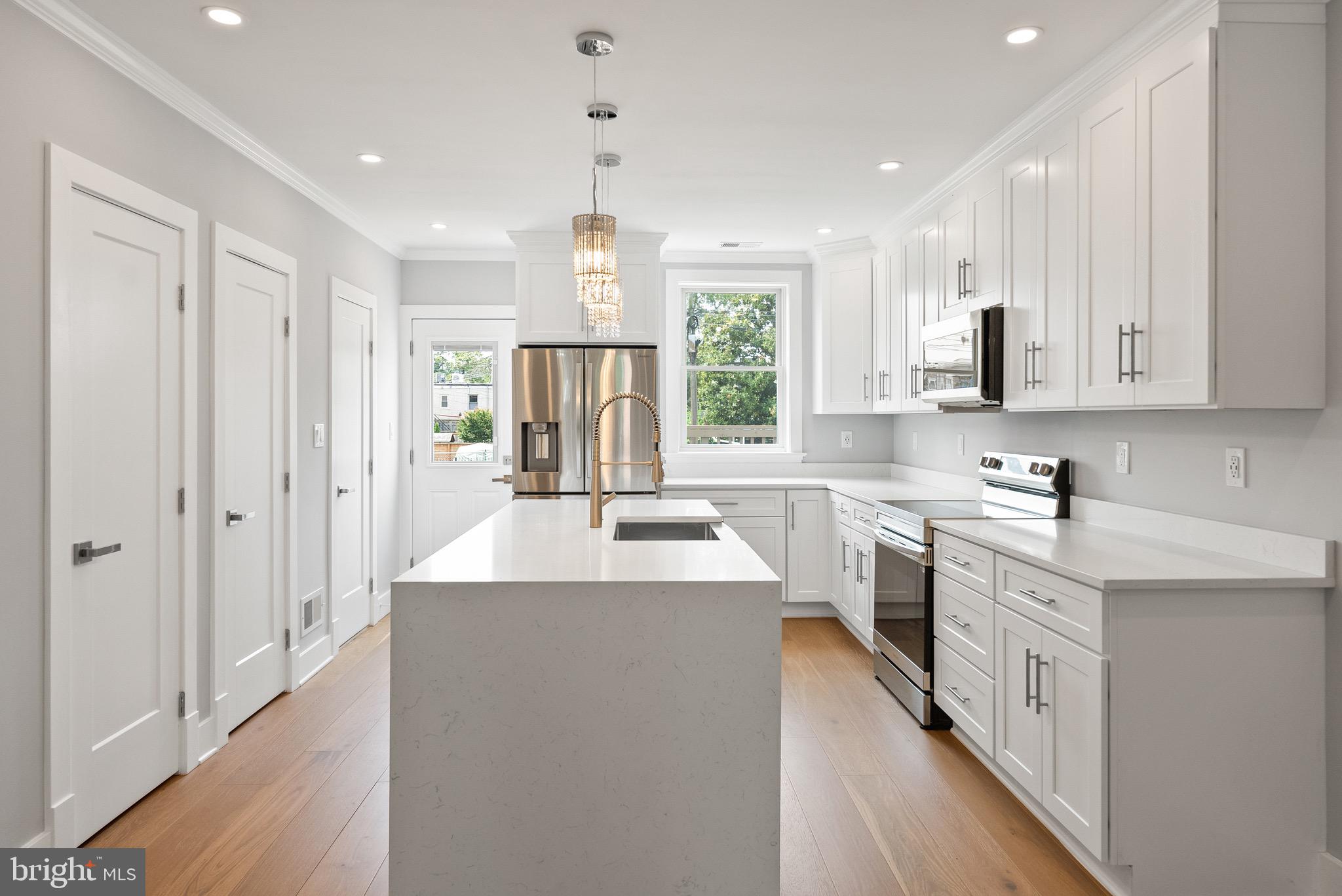 1841 E Street Northeast Washington, DC 20002 - Photo 13 of 50 a kitchen with stainless steel appliances granite countertop a sink stove and refrigerator