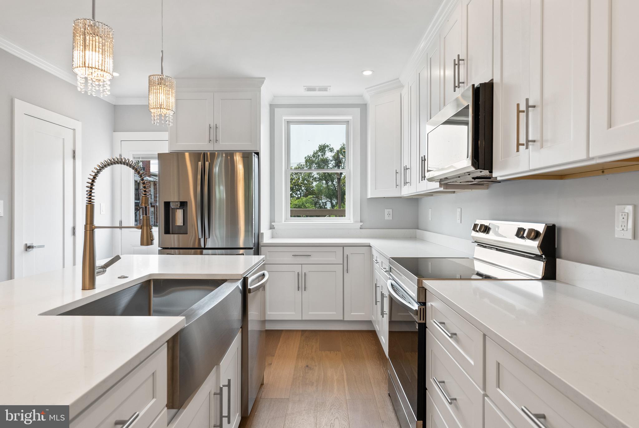 1841 E Street Northeast Washington, DC 20002 - Photo 14 of 50 a kitchen with granite countertop a sink a stove and cabinets