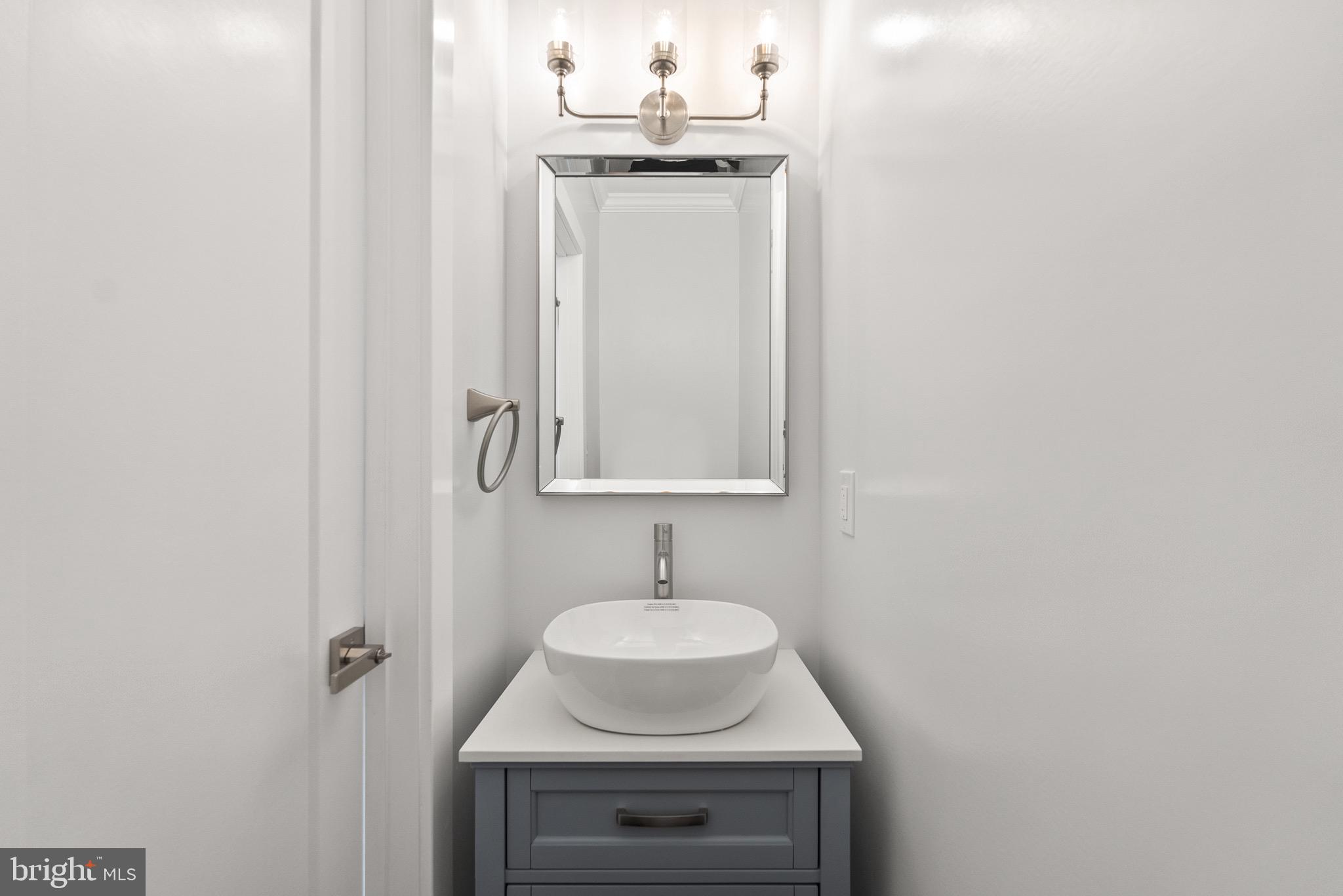 1841 E Street Northeast Washington, DC 20002 - Photo 18 of 50 a bathroom with a sink and a mirror