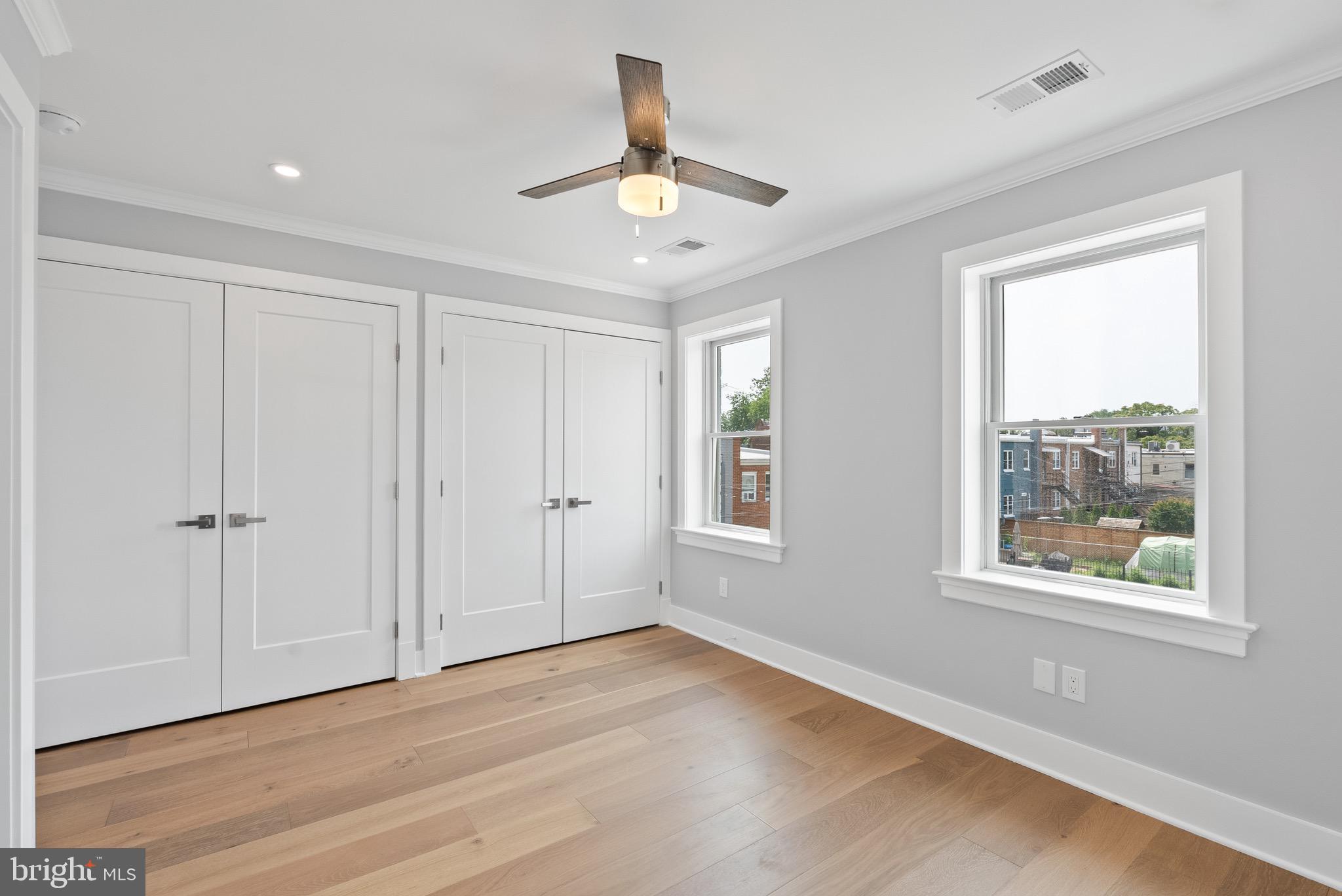 1841 E Street Northeast Washington, DC 20002 - Photo 28 of 50 a view of an empty room with wooden floor and a window