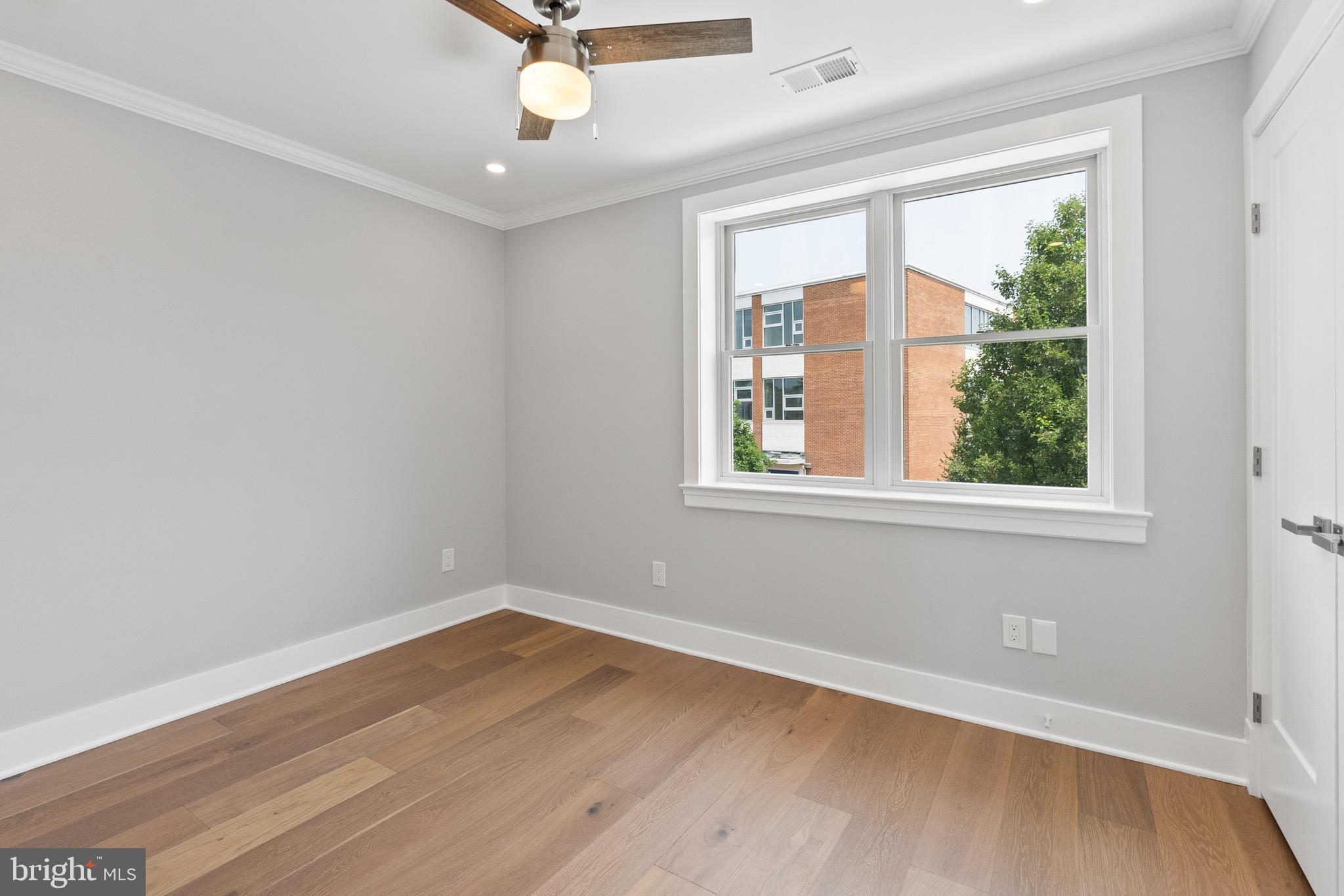 1841 E Street Northeast Washington, DC 20002 - Photo 32 of 50 wooden floor in an empty room with a window
