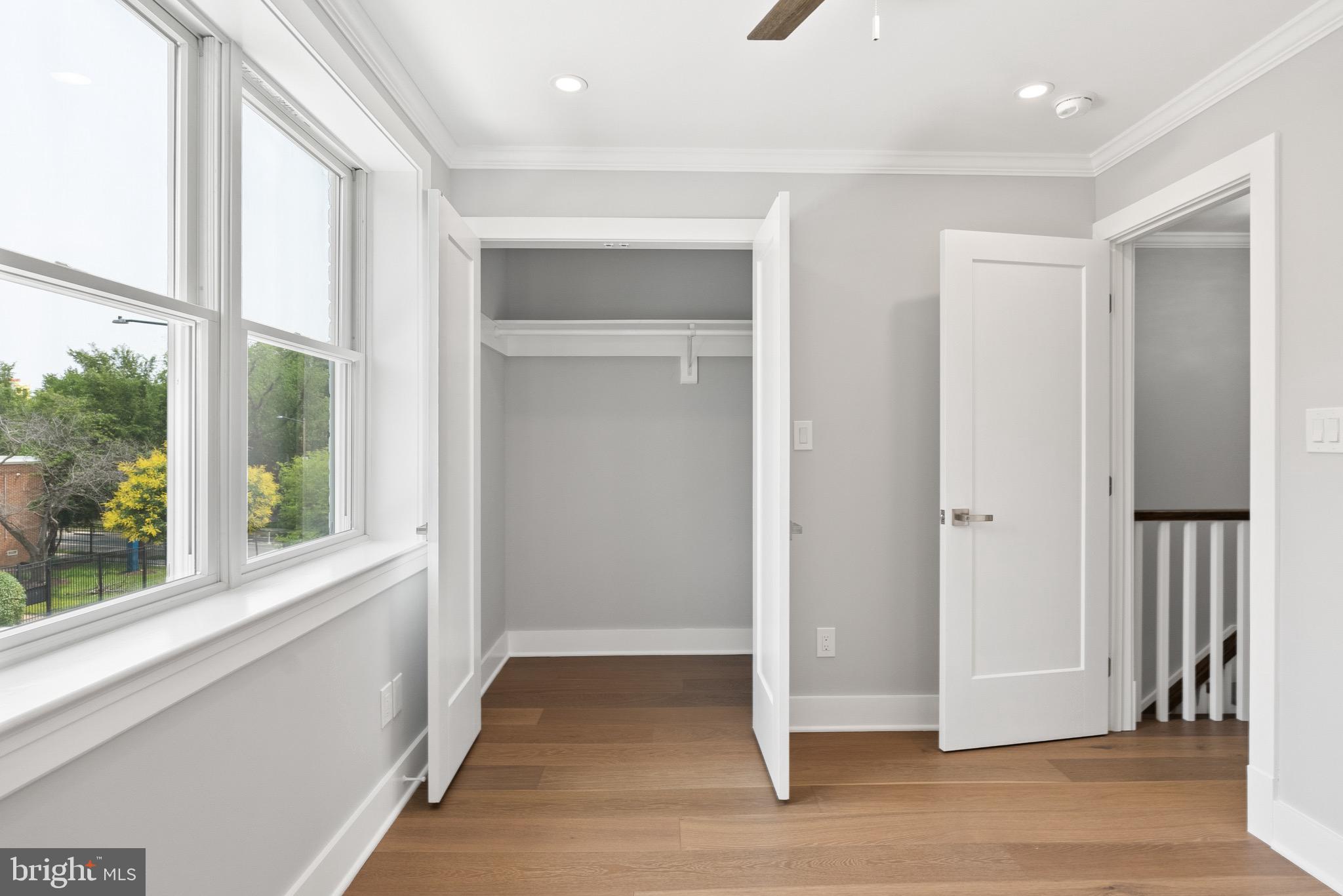 1841 E Street Northeast Washington, DC 20002 - Photo 34 of 50 a view of an empty room with wooden floor and a window