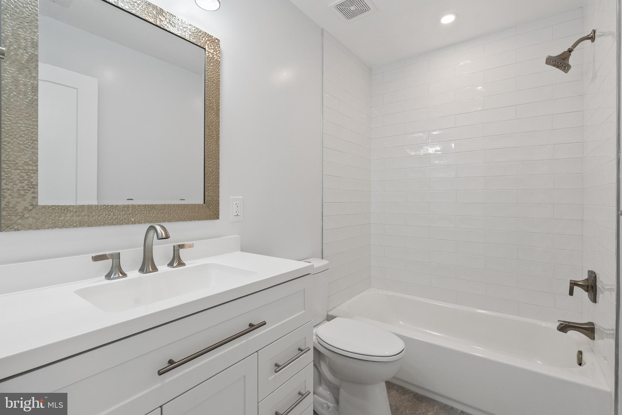 1841 E Street Northeast Washington, DC 20002 - Photo 35 of 50 a bathroom with a sink mirror toilet and bathtub