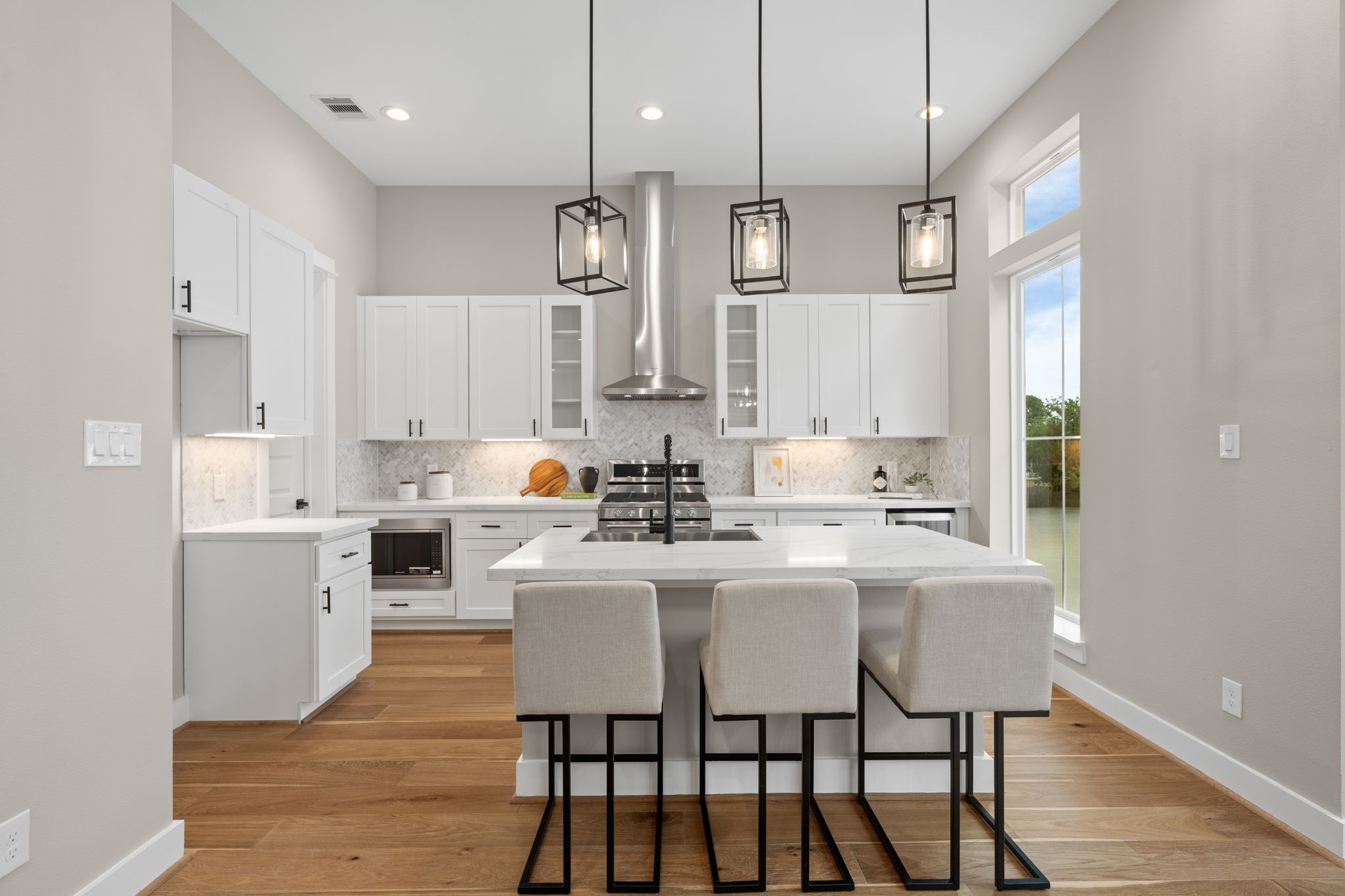 1177 West 19th Street Houston, TX 77008 - Photo 21 of 40 a kitchen with white cabinets and chairs