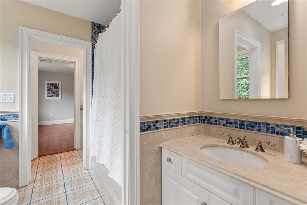 42 Victoria Road Sudbury, MA 01776 - Photo 24 of 42 a bathroom with a granite countertop sink a mirror and shower