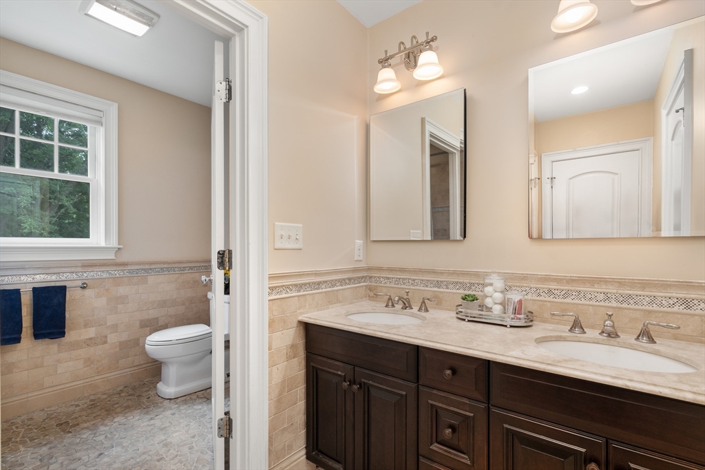 42 Victoria Road Sudbury, MA 01776 - Photo 28 of 42 a bathroom with a double vanity sink toilet and a mirror