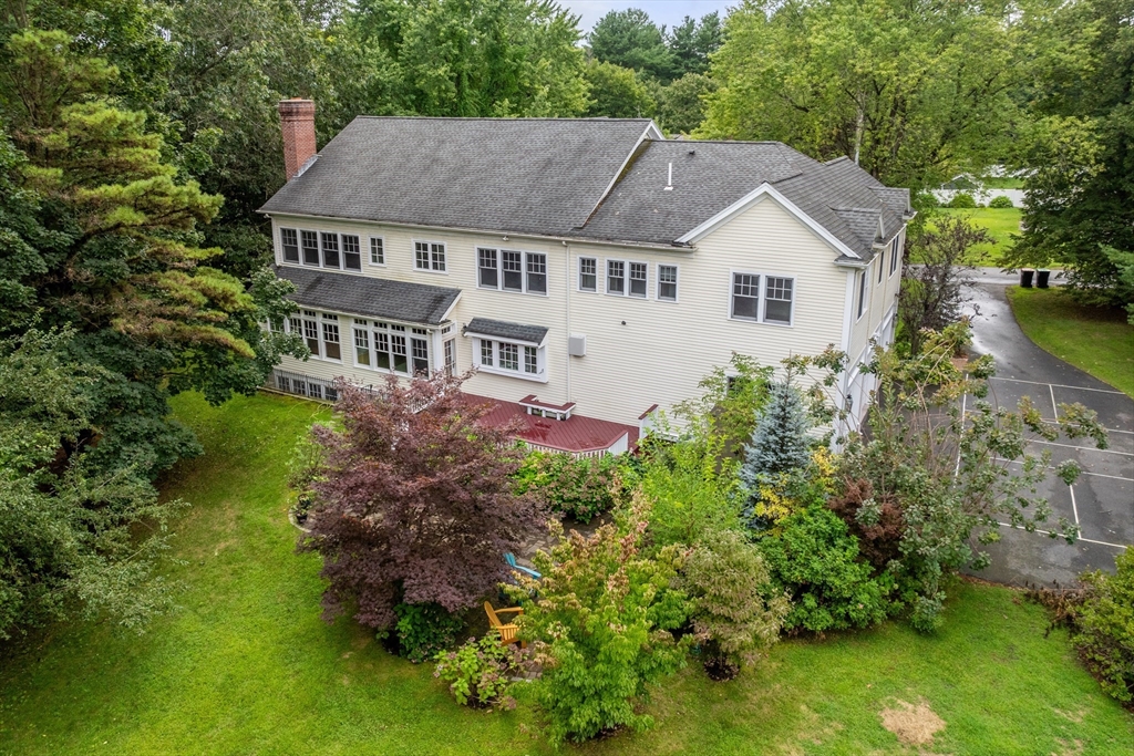 42 Victoria Road Sudbury, MA 01776 - Photo 3 of 42 a aerial view of a house with a yard and potted plants
