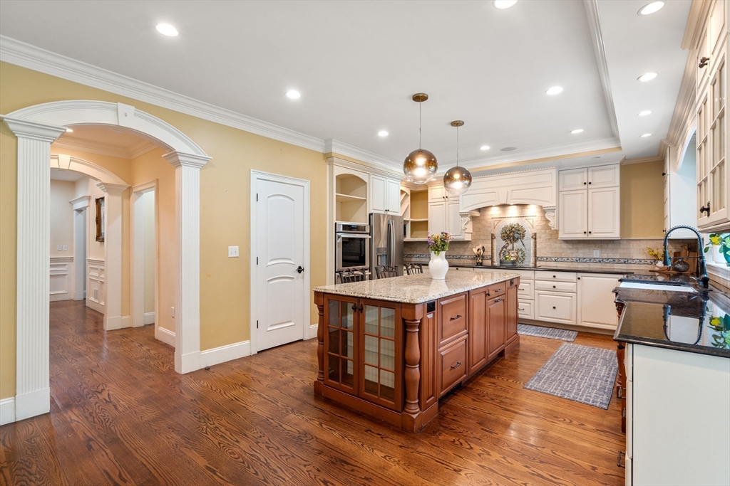 42 Victoria Road Sudbury, MA 01776 - Photo 7 of 42 a large kitchen with stainless steel appliances granite countertop a large counter top and a wooden floors