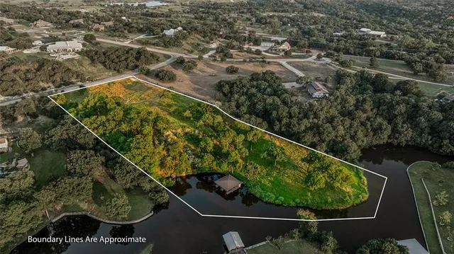 an aerial view of a residential houses with outdoor space and swimming pool