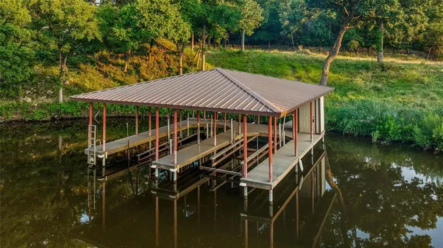 a roof deck with table and chairs under an umbrella