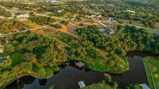 an aerial view of residential house with outdoor space and trees all around