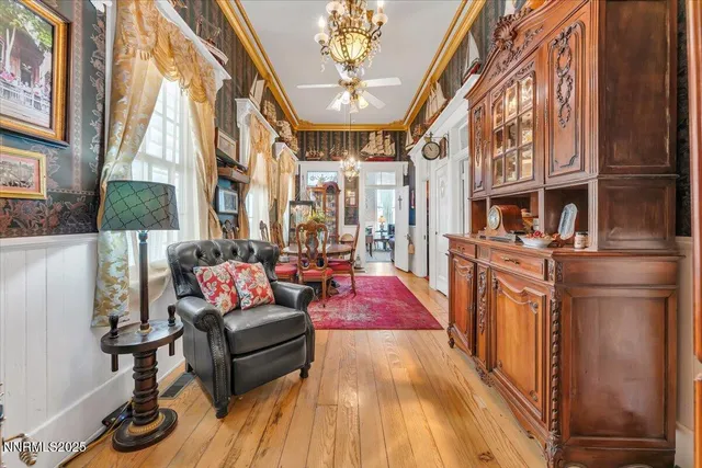 a living room with furniture and a chandelier