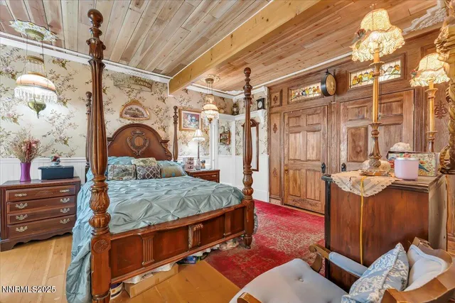 a bedroom with a bed next to a window with the outer view