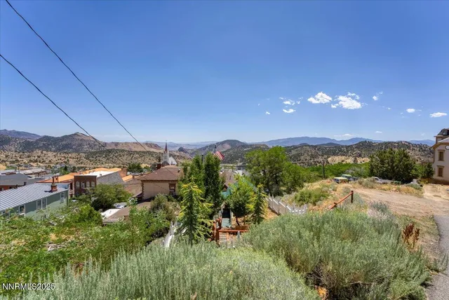 a aerial view of a house with swimming pool and glass windows