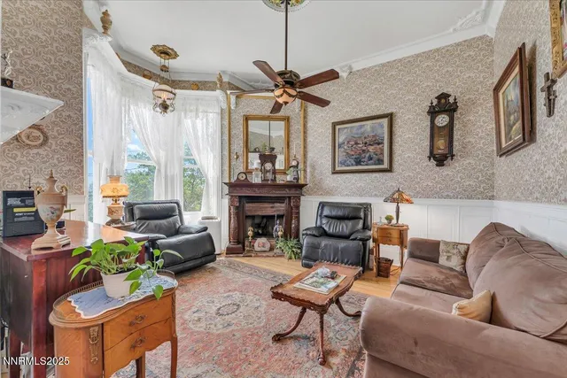 a living room with furniture a fireplace and a chandelier