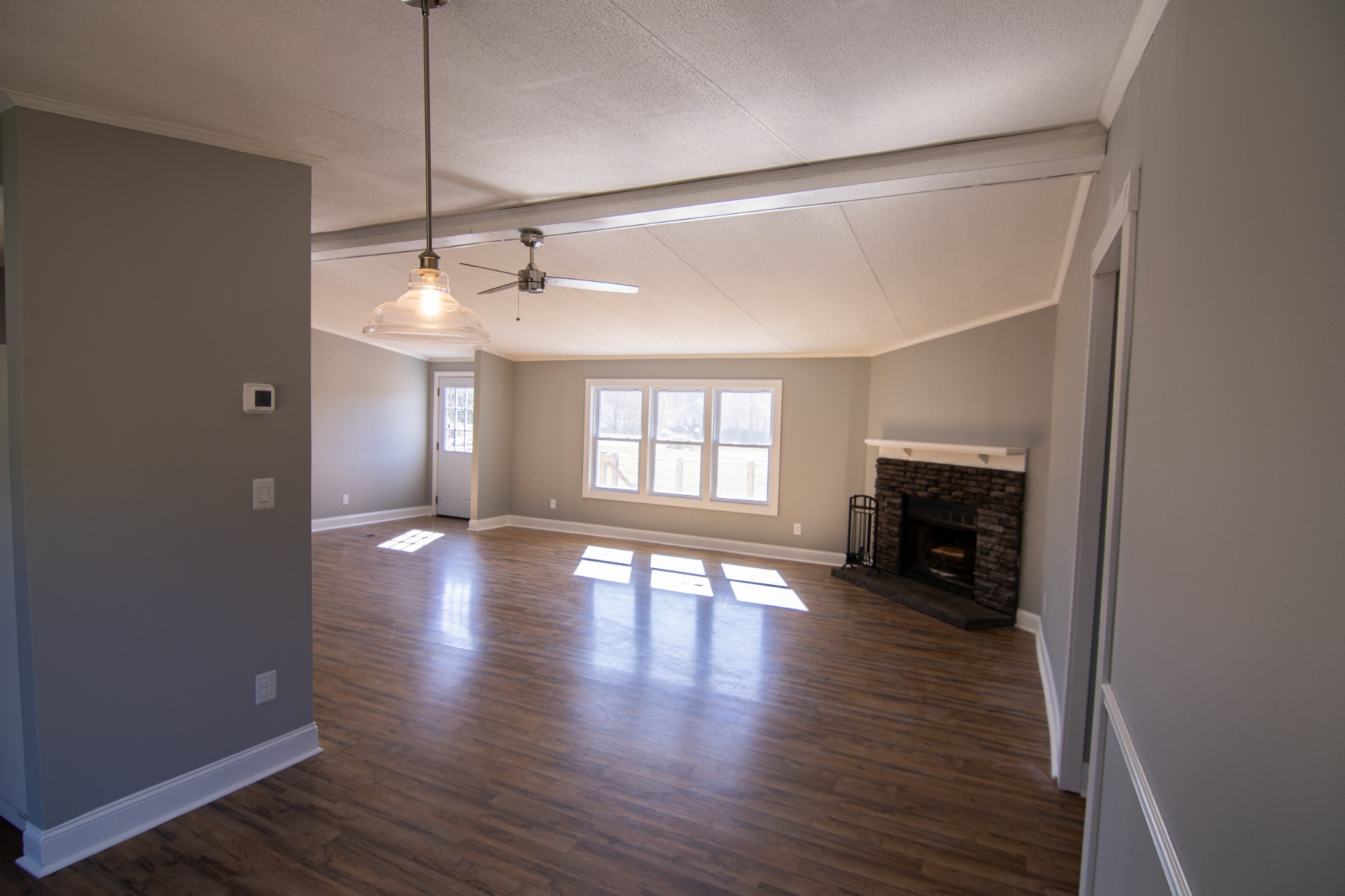1712 John Sharp Road Spring Hill, TN 37174 - Photo 4 of 22 a view of an empty room with wooden floor and a window