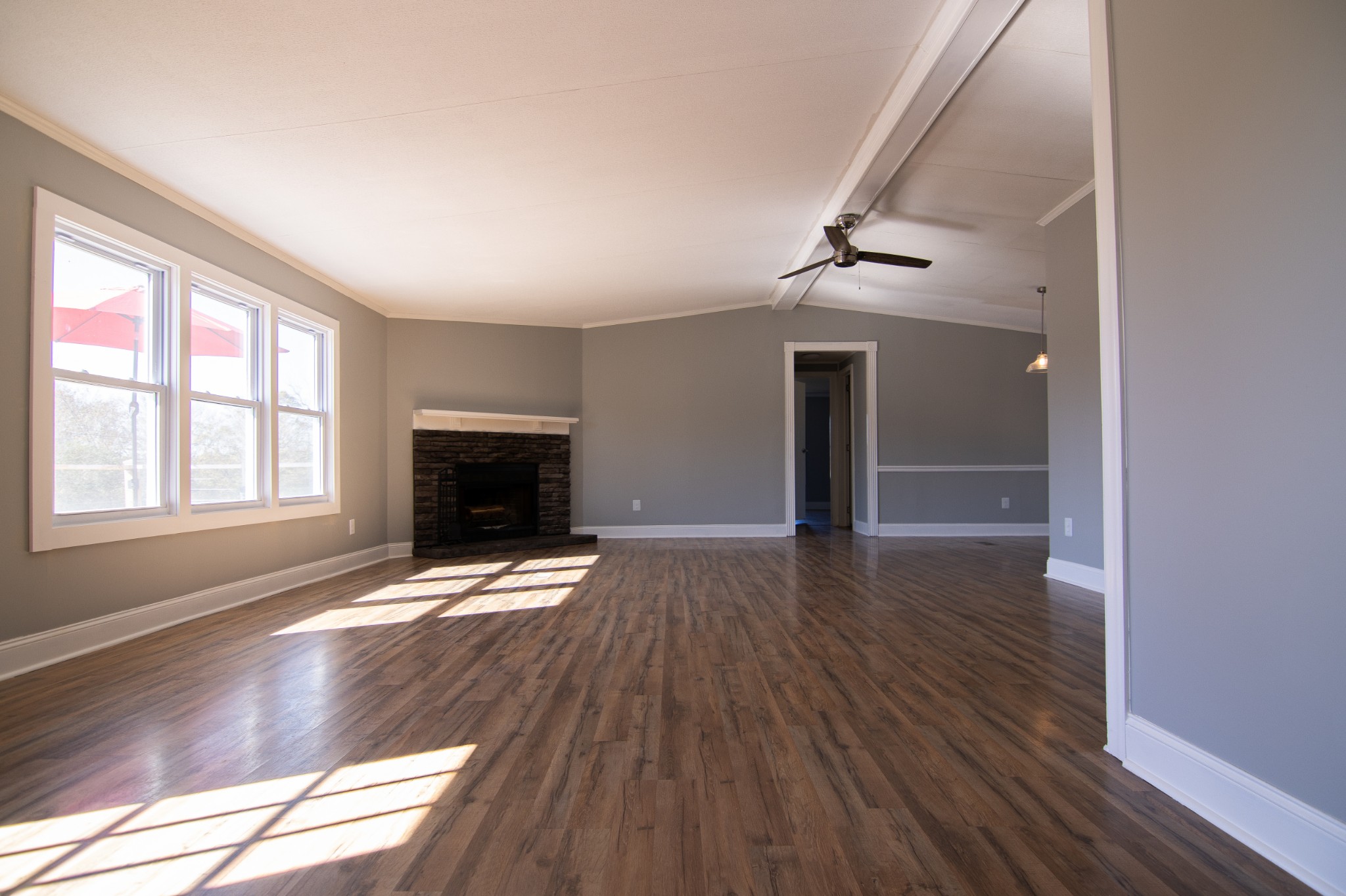 1712 John Sharp Road Spring Hill, TN 37174 - Photo 5 of 22 an empty room with wooden floor fireplace and windows
