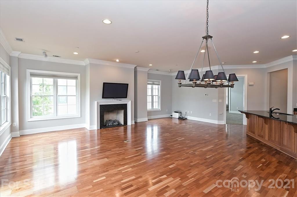 626 Queens Road, Unit 203 Charlotte, NC 28207 - Photo 15 of 48 a view of a living room a flat screen tv and a fireplace