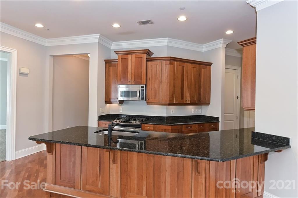 626 Queens Road, Unit 203 Charlotte, NC 28207 - Photo 23 of 48 a kitchen with stainless steel appliances granite countertop a sink a stove and a refrigerator