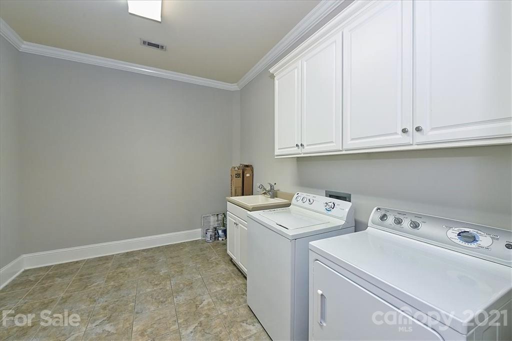 626 Queens Road, Unit 203 Charlotte, NC 28207 - Photo 31 of 48 a view of storage and utility room with washer and dryer